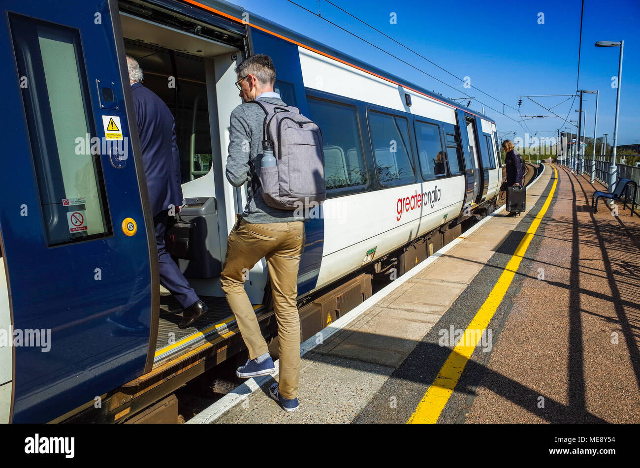 Passengers board a Greater Anglia train at Whittlesford Parkway station (south of Cambridge), bound for London Liverpool Street station. Stock Photo