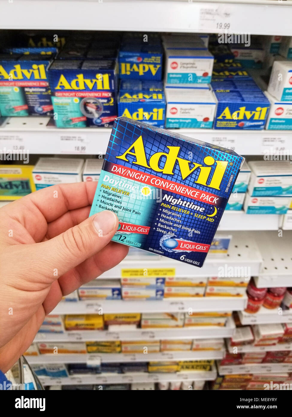 MONTREAL, CANADA - MARCH 10, 2018 : A hand holding Advil pack. Advil ibuprofen is a nonsteroidal anti-inflammatory drug NSAID Stock Photo