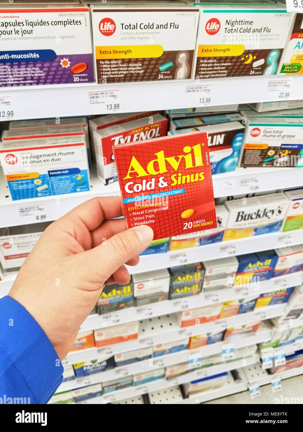 MONTREAL, CANADA - MARCH 10, 2018 : A hand holding Advil pack. Advil ibuprofen is a nonsteroidal anti-inflammatory drug NSAID Stock Photo