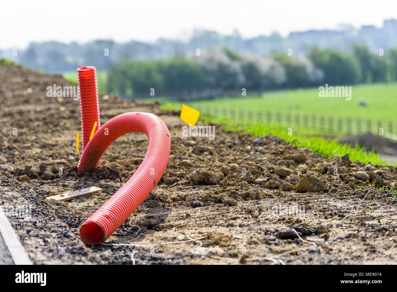 Day view coiled orange tubing pipe on construction ground Stock Photo