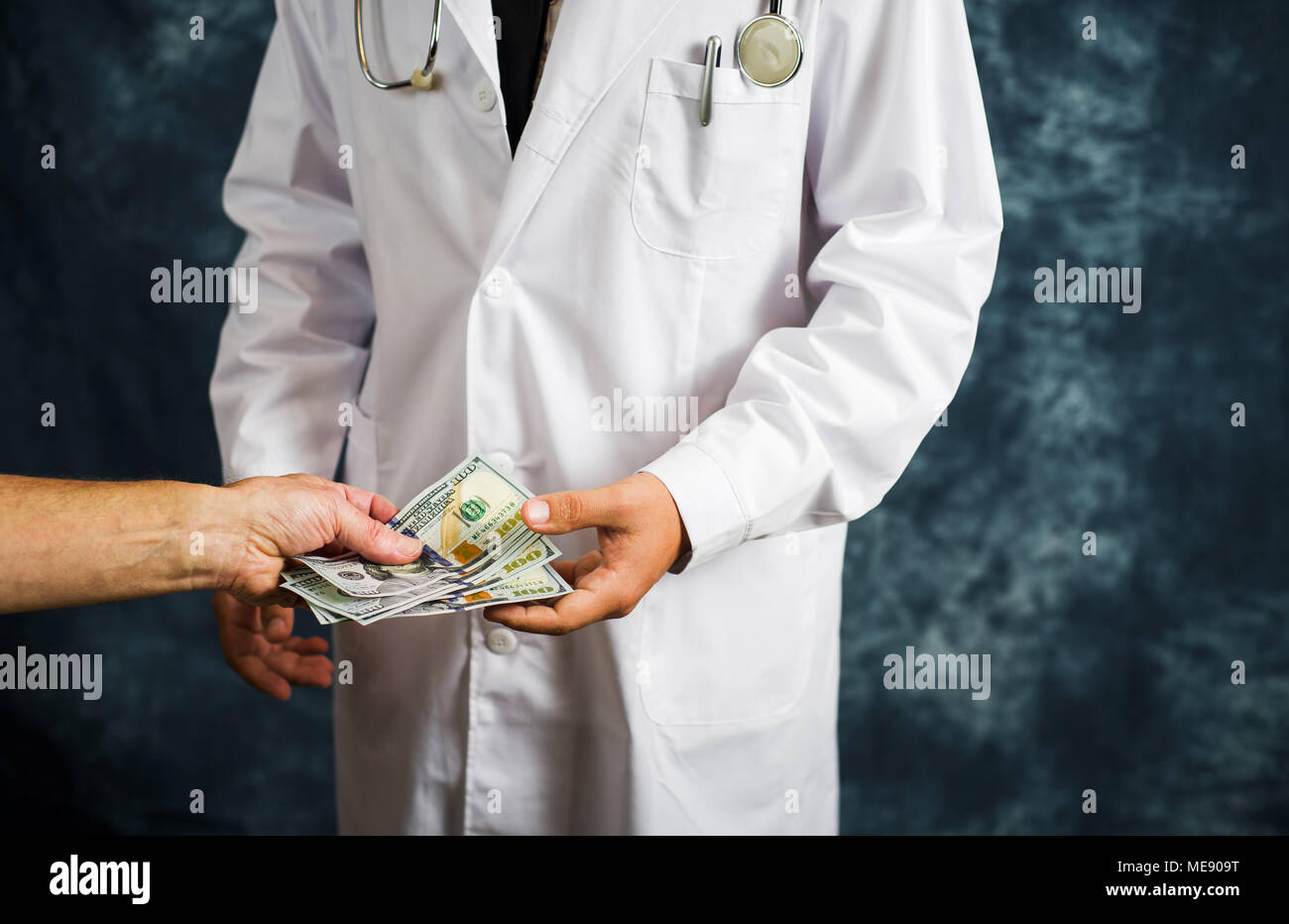 Doctor accepting money bills close up, bribery concept Stock Photo