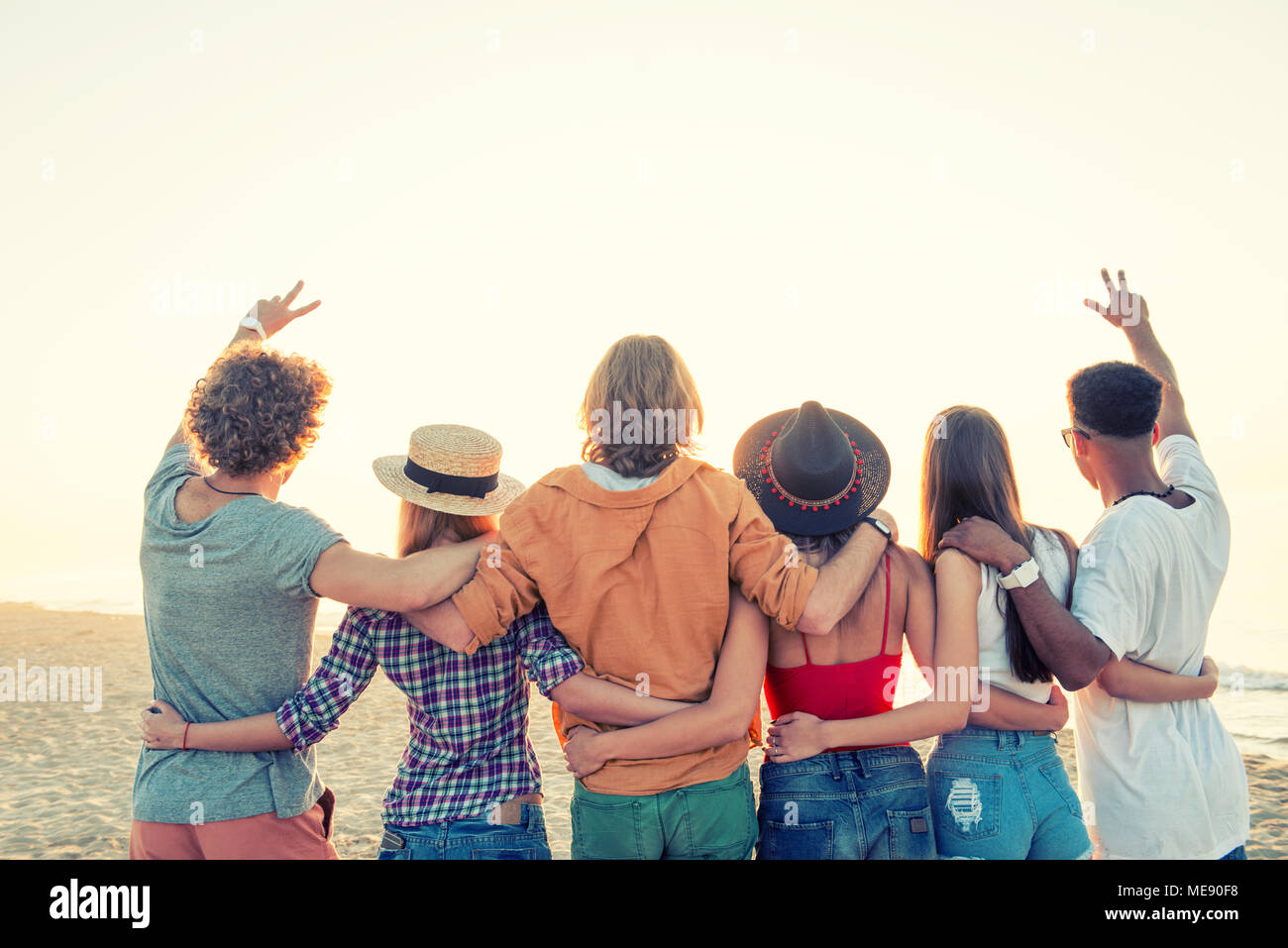 Group of happy friends having fun at ocean beach Stock Photo