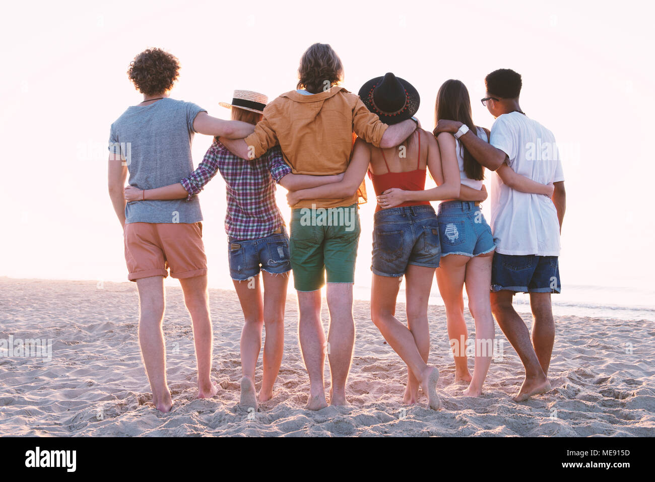 Group of happy friends having fun at ocean beach Stock Photo