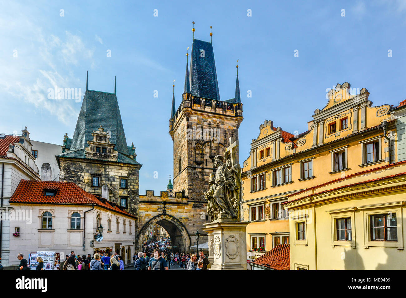 Tourists cross the Charles Bridge on the Path of the Kings leading to the lesser Tower on their way to Prague Castle. Stock Photo