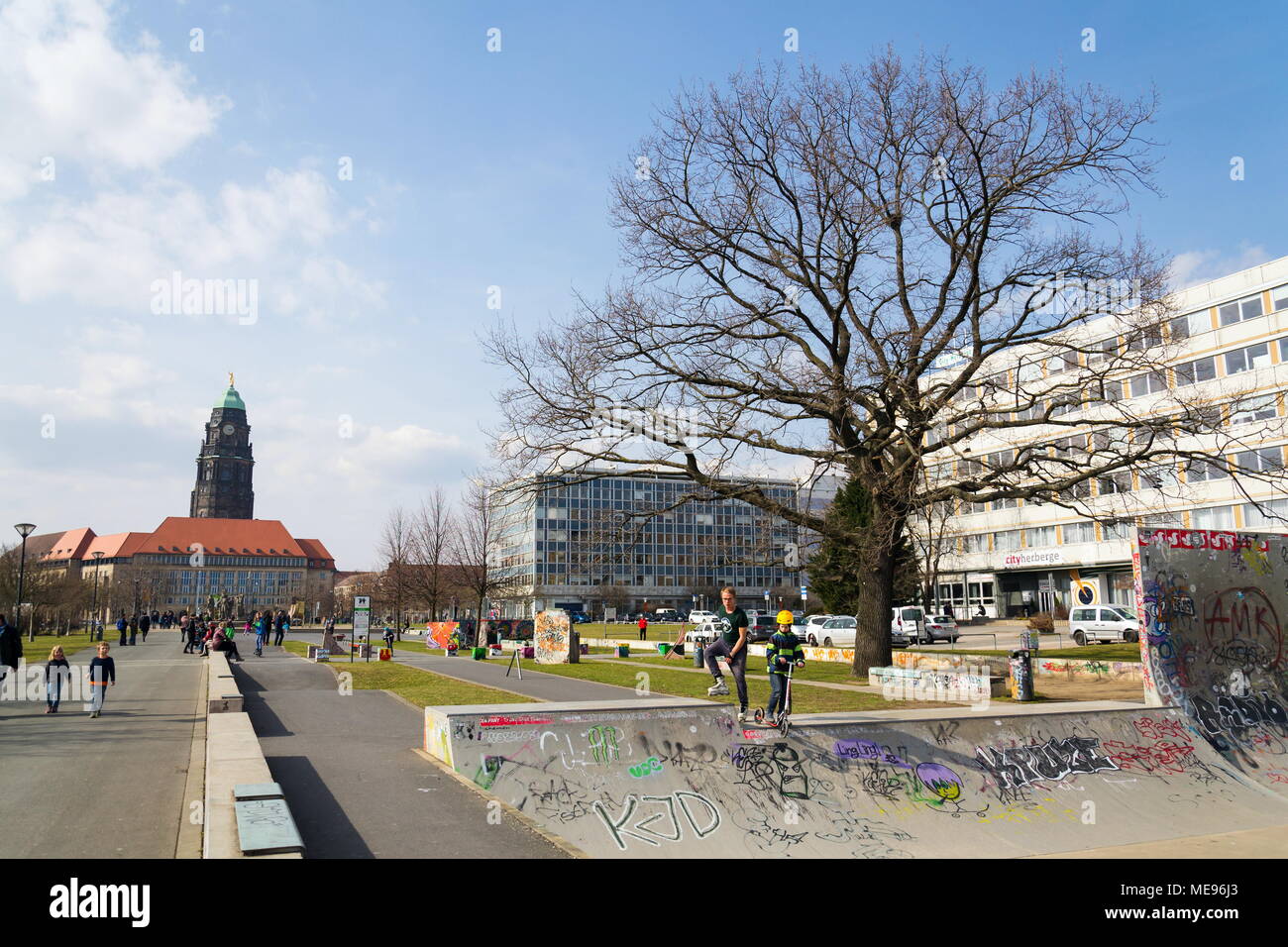 DRESDEN, GERMANY - APRIL 1 2018: People in Lingneralle skatepark with City Hall in background on April 1, 2018 in Dresden, Germany. Stock Photo