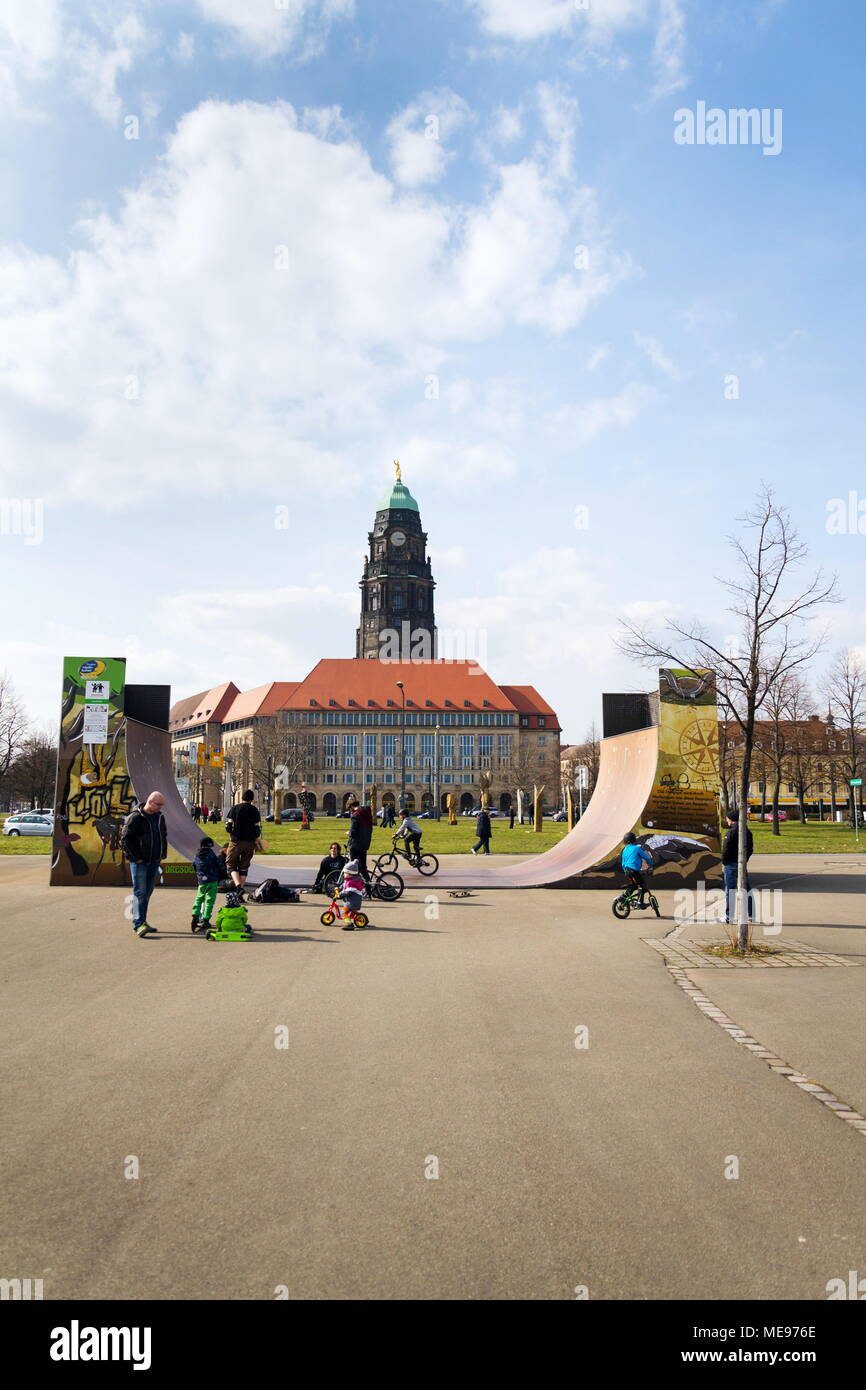 DRESDEN, GERMANY - APRIL 1 2018: People in Lingneralle skatepark with City Hall in background on April 1, 2018 in Dresden, Germany. Stock Photo