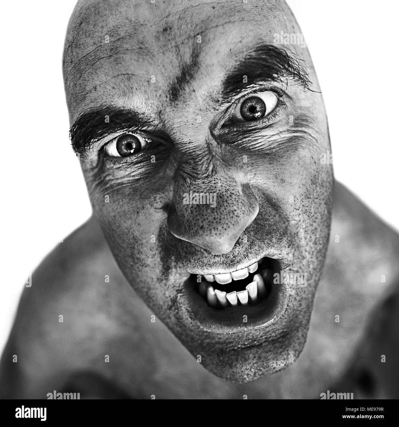 Black and white portrait of mad man processed using the dragan effect. Stock Photo