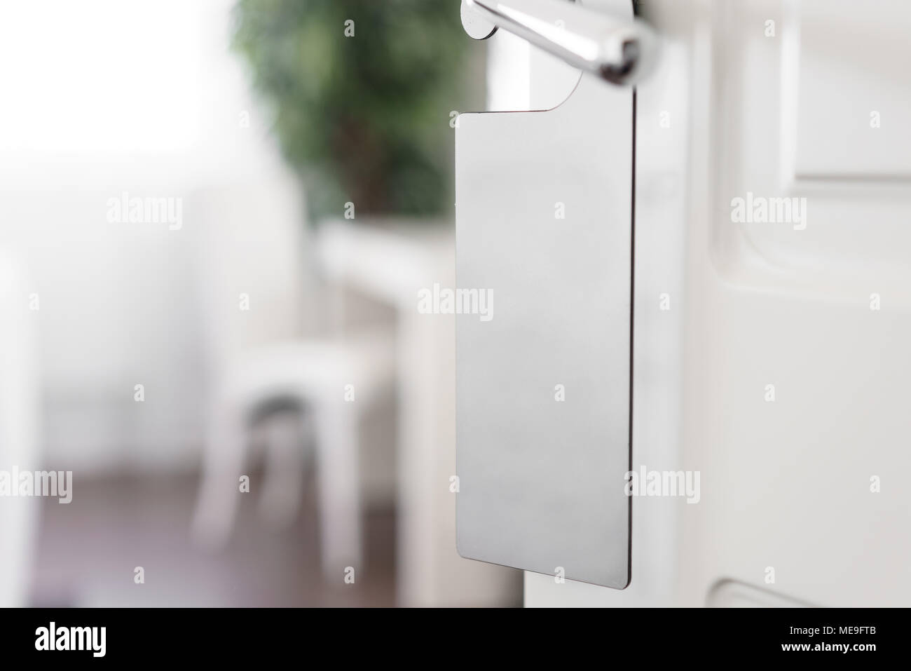 Door knob with empty label on a door handle for your text. Empty white