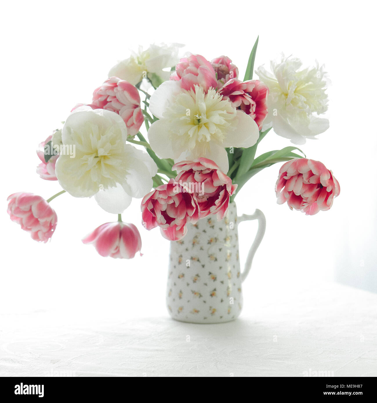 Tulips and Peonies in a pitcher Stock Photo