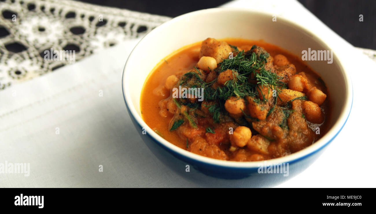 Simple vegetable soup. European cuisine. Chickpeas, potato and carrot. Organic food. Vegan dish. Vegetarian lunch. Wide photo. Stock Photo