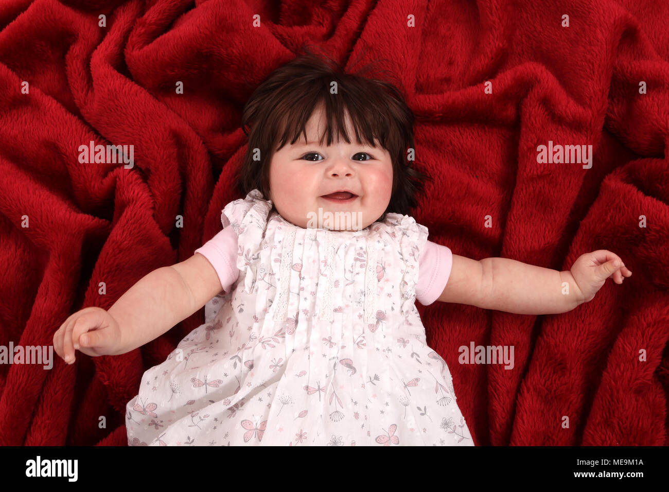 3 month old baby girl exploring in the nursery, cognitive development Stock Photo