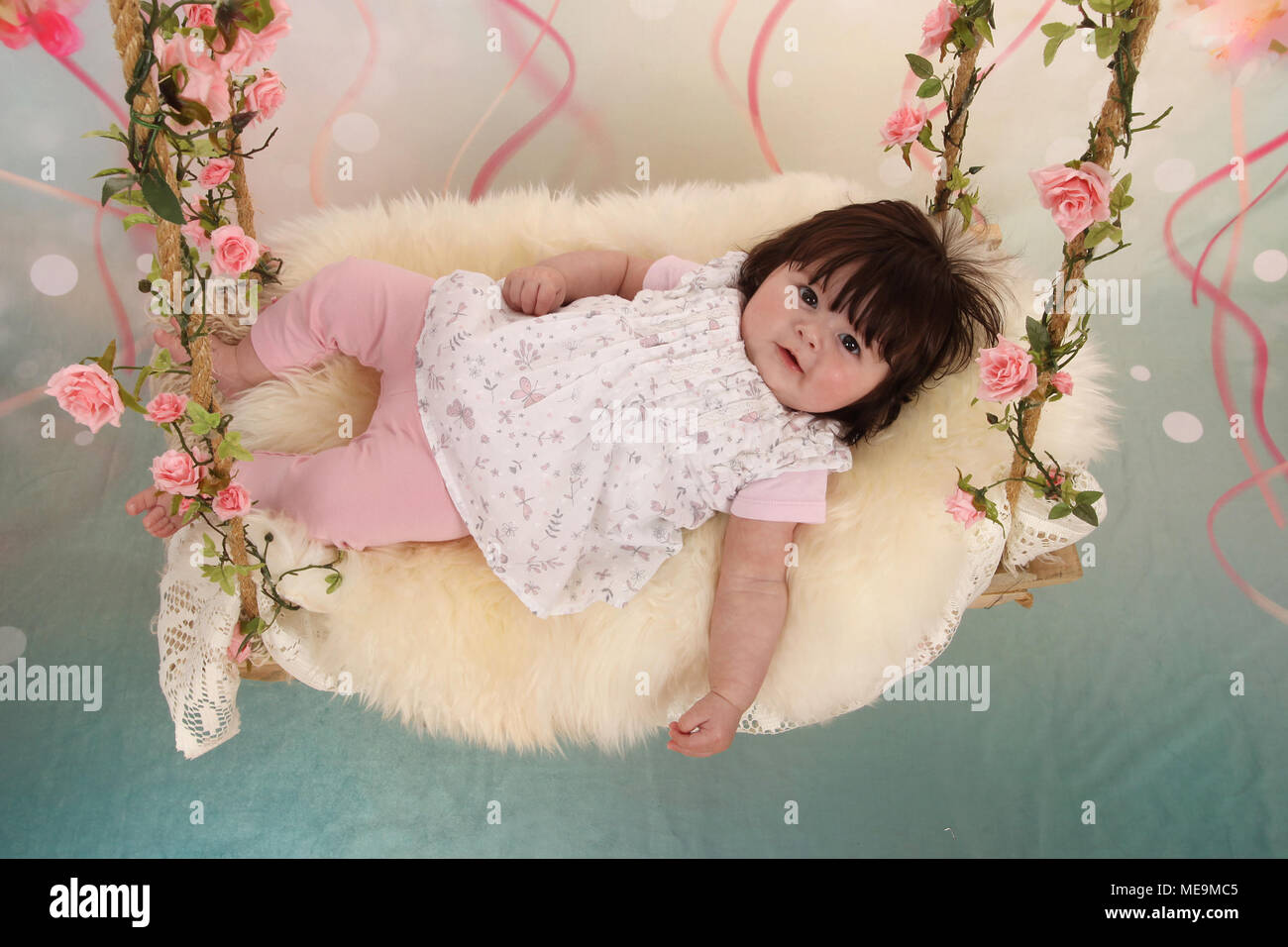 3 month old baby girl exploring in the nursery, cognitive development Stock Photo