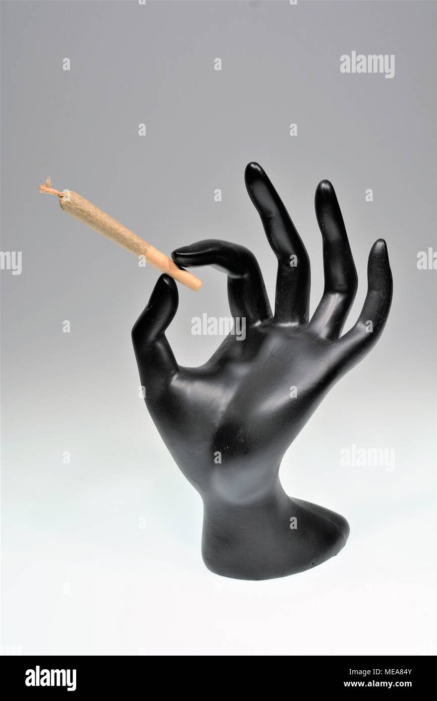 Hand holding Marijuana Joint Stock Photo