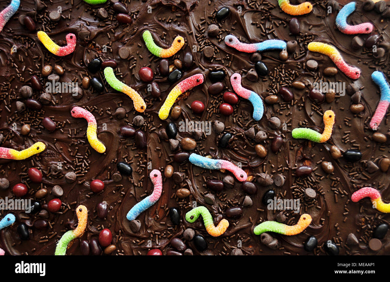 Chocolate icing with candy background Stock Photo