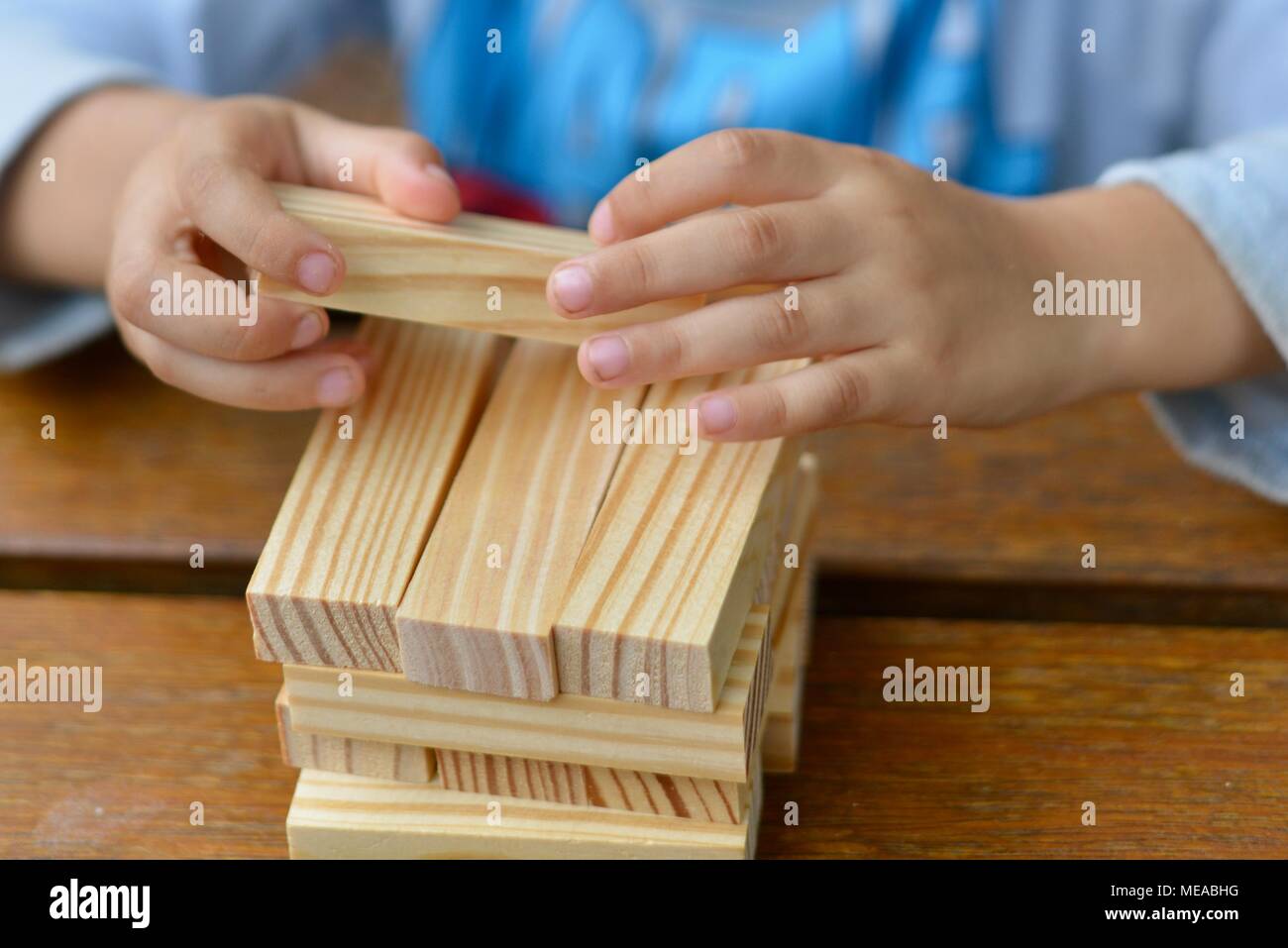 Cute child playing with building blocks and developing fine motor
