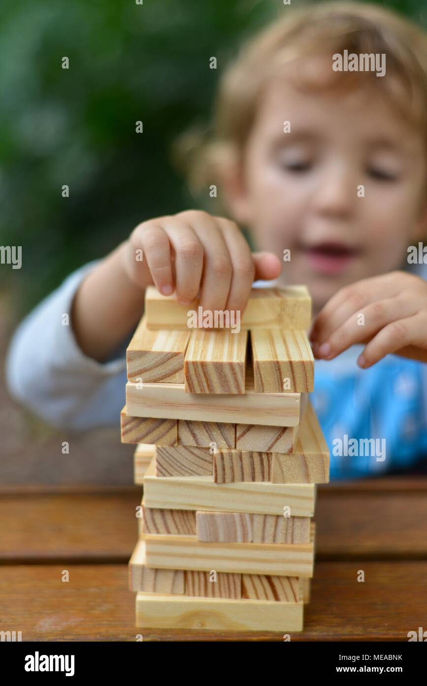 Cute child playing with building blocks and developing fine motor