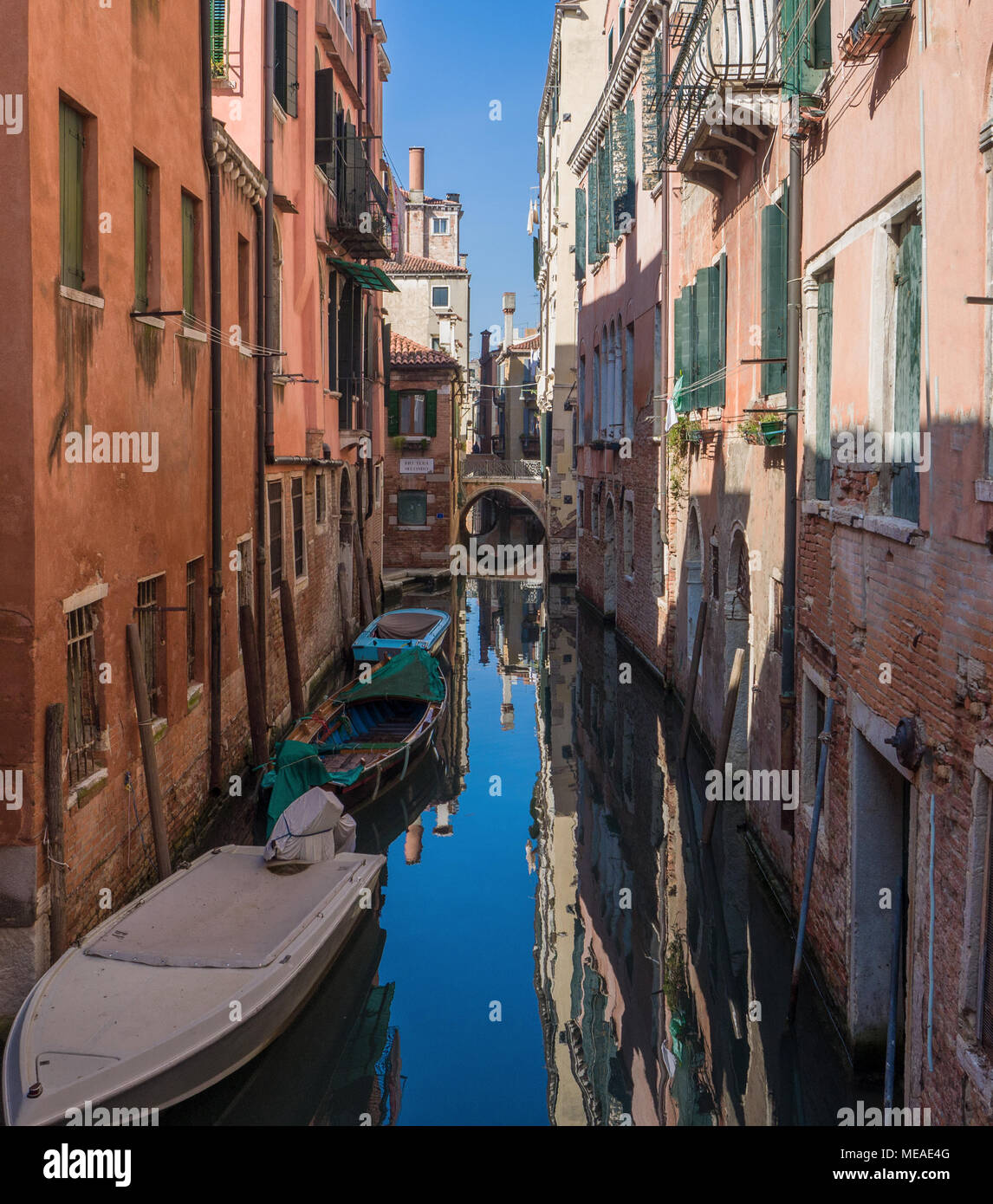 sunny Venetian district with the reflections of the ancient houses in the canal. Venice,Italy Stock Photo