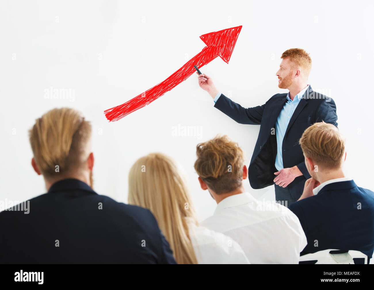 Businessman draws positive statistics of his company during a training meeting. Concept of success Stock Photo
