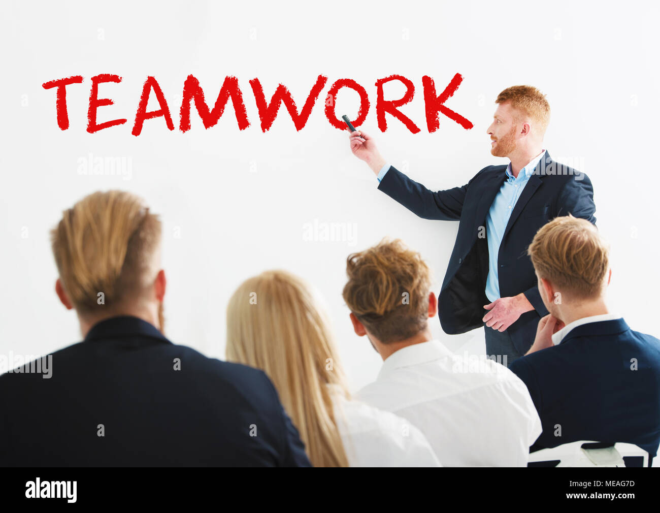 Businessman in office explain something about teamwork at a training meeting Stock Photo