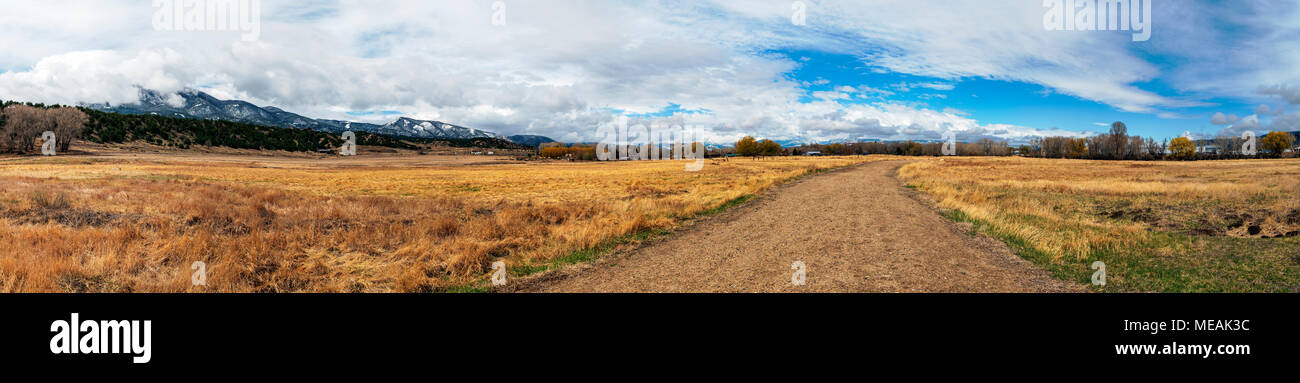 Dirt road; panaroma view of Sawatch Range, Rocky Mountains, the Arkansas River Valley; Vandaveer Ranch; near historic Salida, Colorado, USA Stock Photo