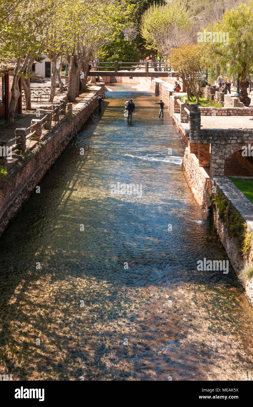 Portuguese council workers clear algae from the natural spring swimming pool at Alté, Algarve, Portugal. Stock Photo