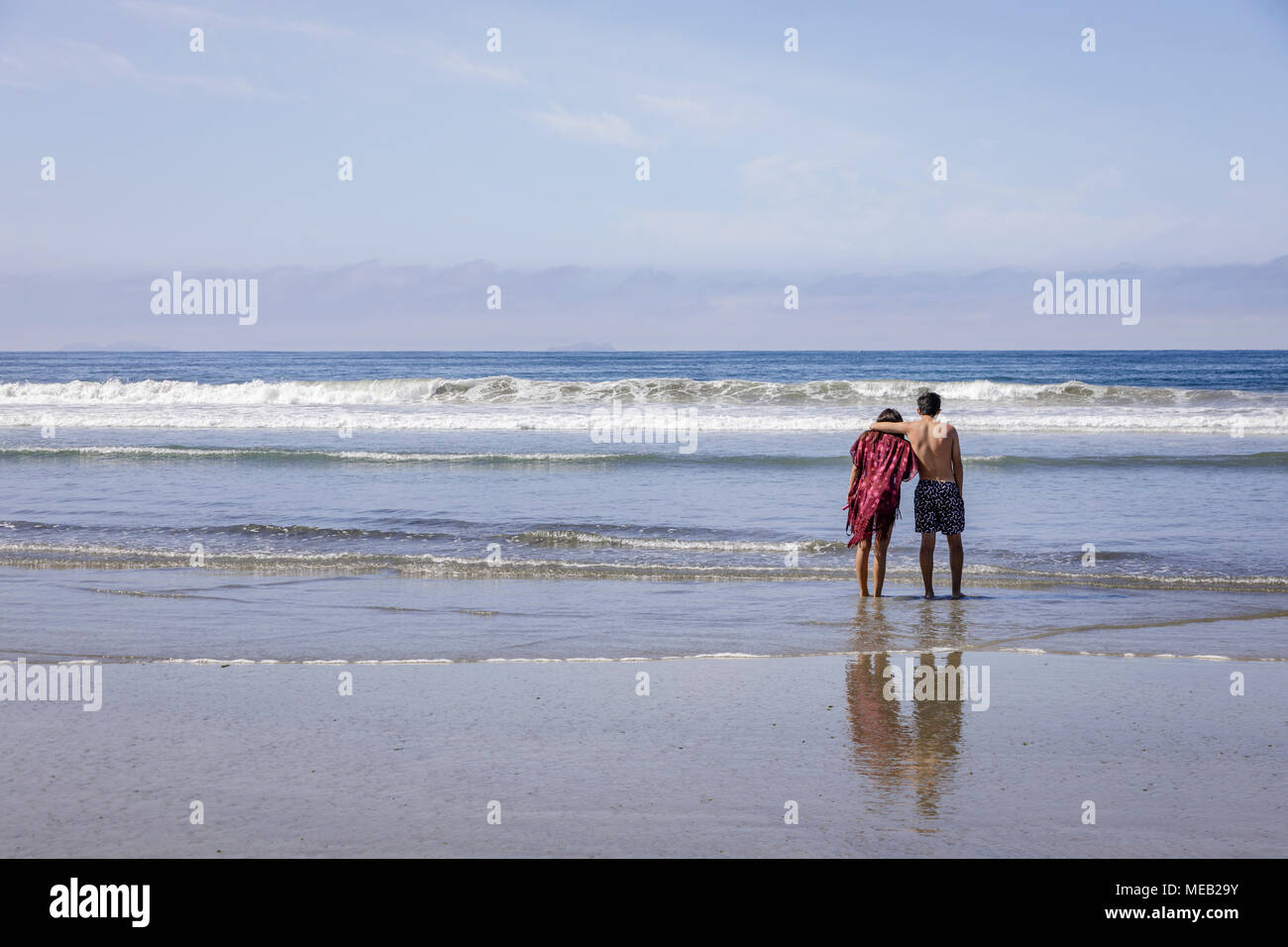Carefree young couple spending time together of a beach. Stock Photo