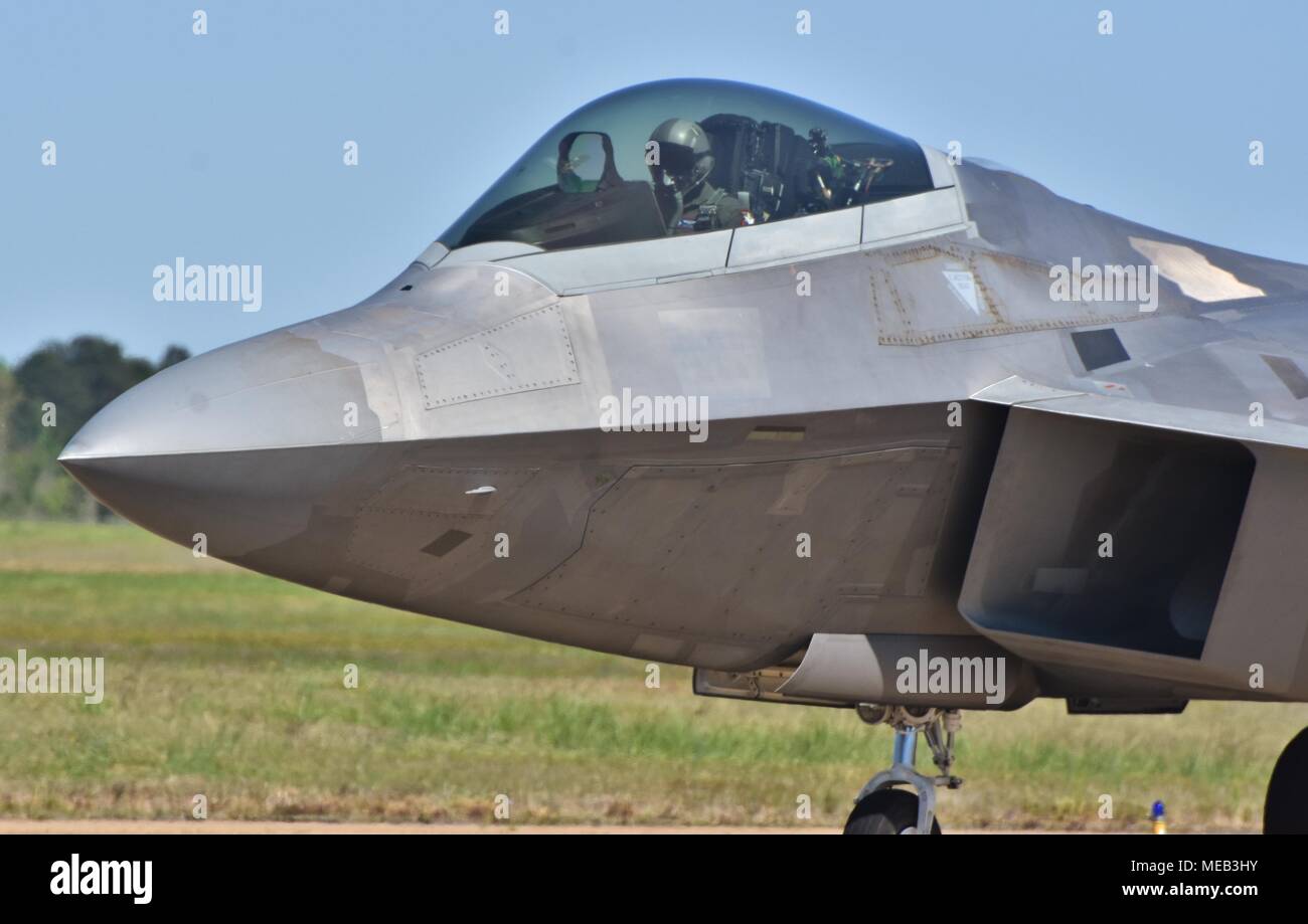 An Air Force pilot in the cockpit of a taxiing F-22 Raptor on the runway at Columbus Air Force Base. Stock Photo