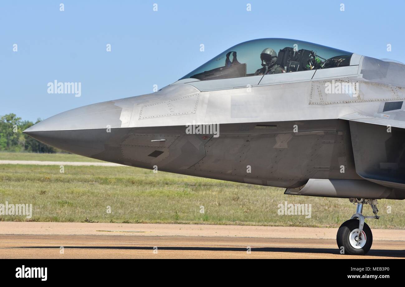 An Air Force pilot in the cockpit of a taxiing F-22 Raptor on the runway at Columbus Air Force Base. Stock Photo