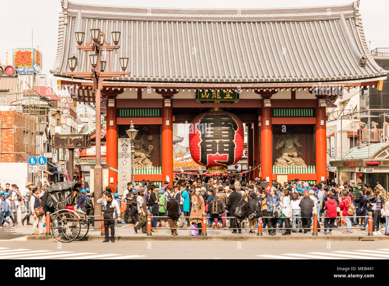 People tourist and visitors enjoying shopping exploring and walking around the area around Asakusa Kannon Temple a Buddhist temple in Tokyo Japan. Stock Photo
