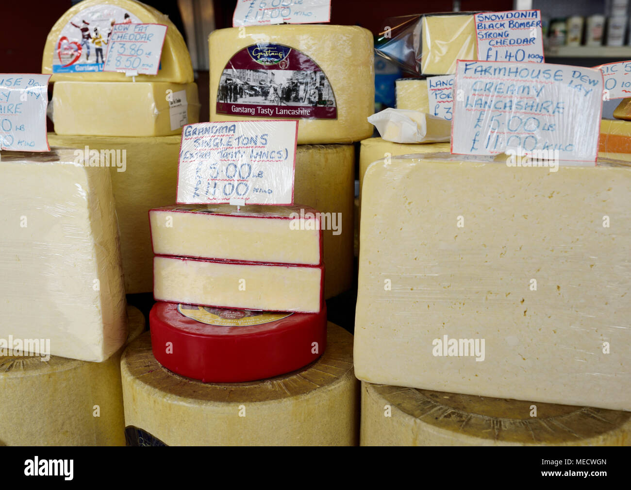 Cheeses for sale on market stall on Bury market in bury lancashire uk