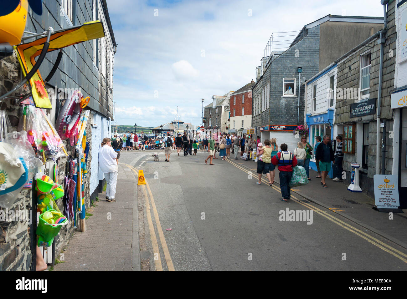 Padstow, Cornwall, UK - August 29, 2007: Looking along a busy street towards Padstow harbour with crowds of tourists on a summer day Stock Photo