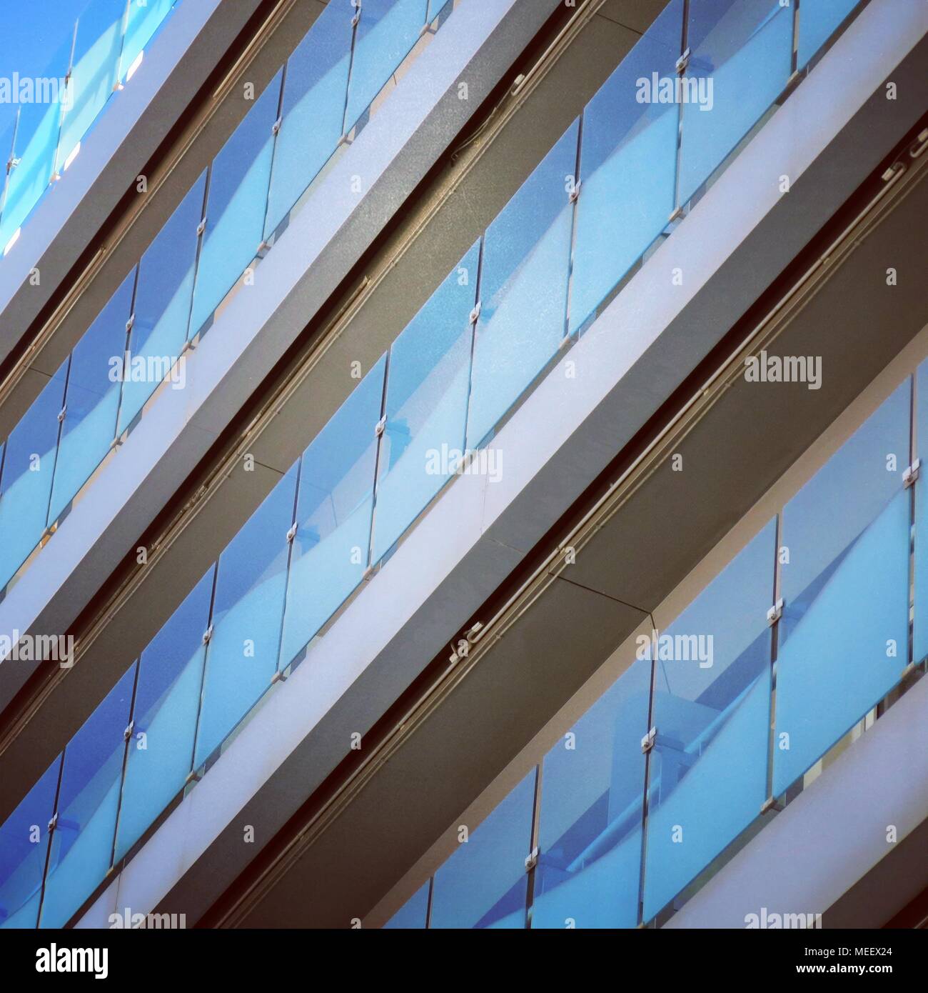 Blue repetitive pattern on balconies. Stock Photo