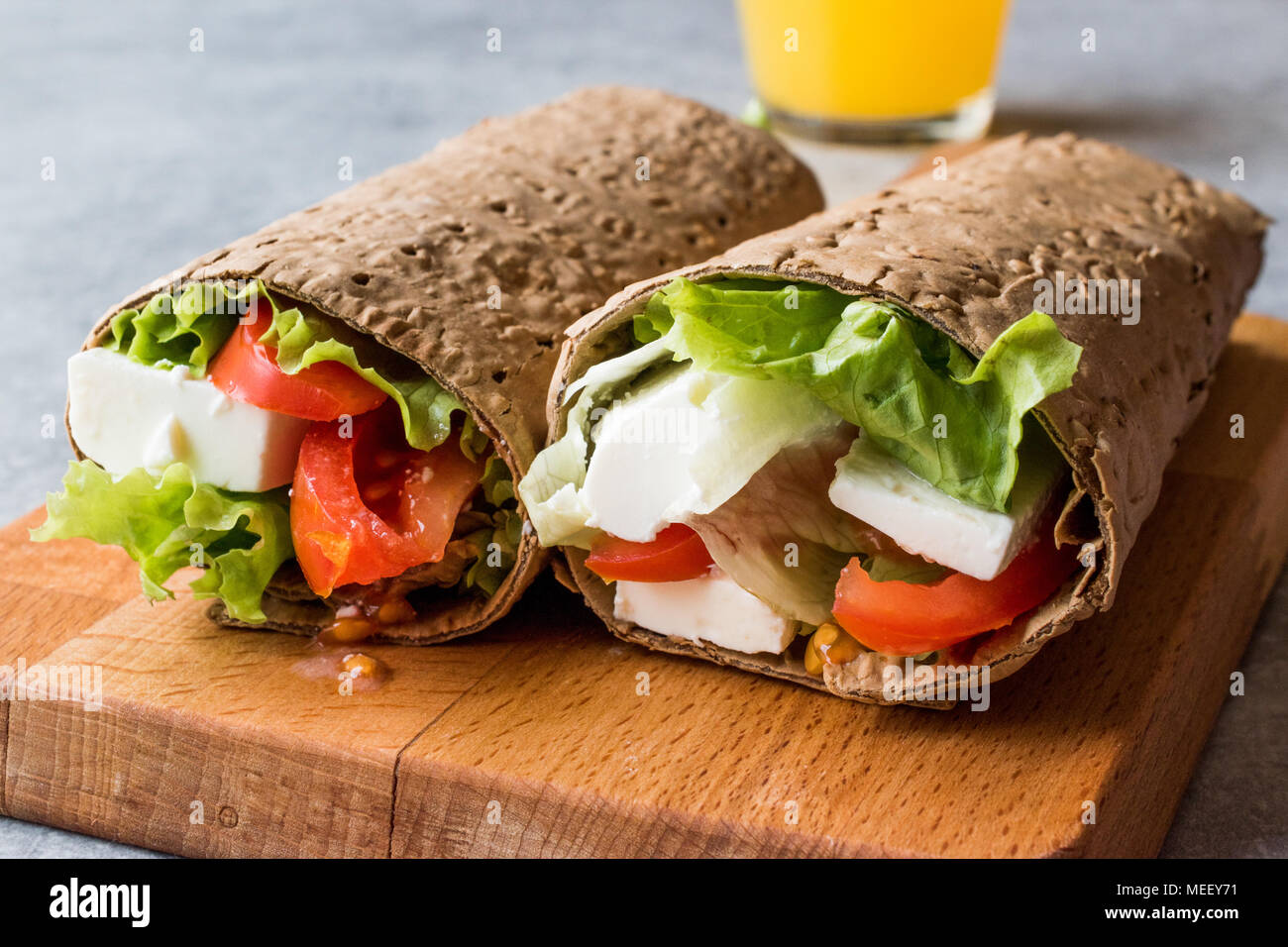 Low Calorie Diet Wrap with Cheese, Tomatoes, Salad and Orange Juice. Organic Food Stock Photo