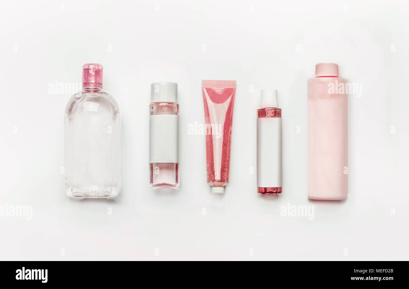 Pink natural cosmetic products : gel, lotion, serum, micellar water and toner,   bottles and tubes with branding mock up on white desk background , to Stock Photo