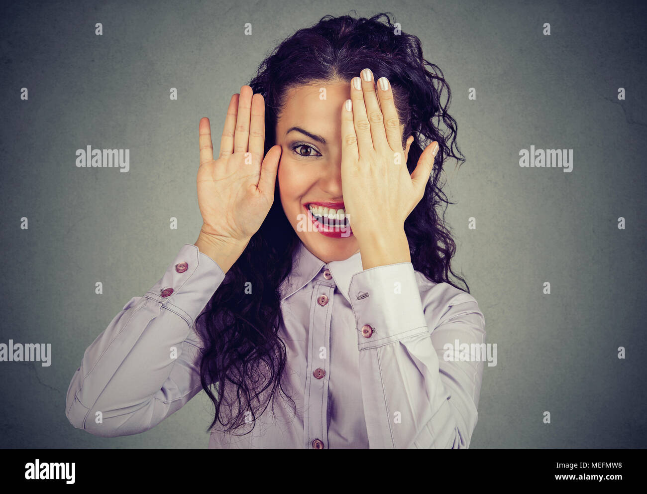 Laughing woman covering her face hires stock photography and images