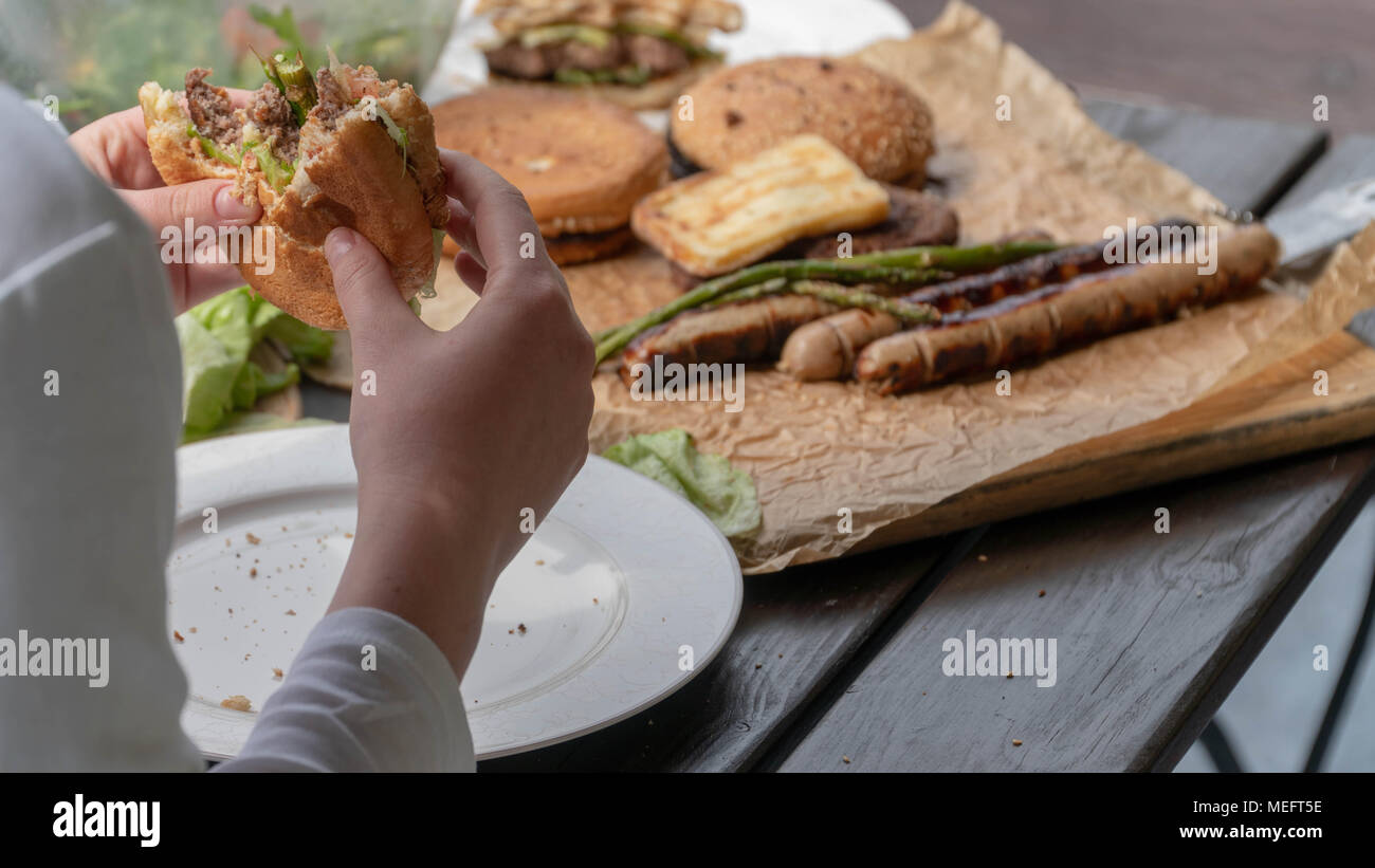 Young girl eating fresh burger, Junk food. selective focus. Stock Photo