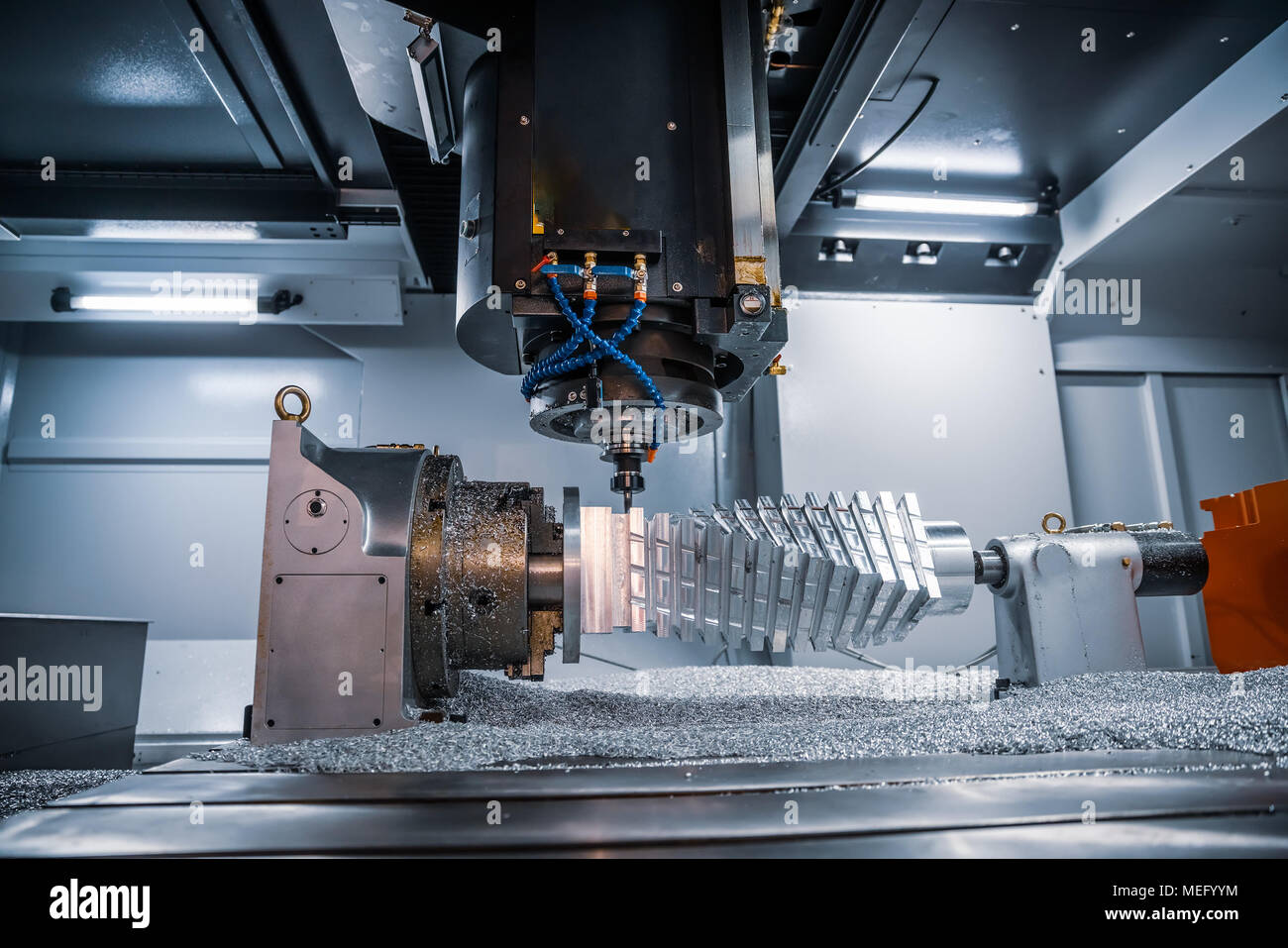 Metalworking CNC milling machine. Cutting metal modern processing technology. Small depth of field. Warning - authentic shooting in challenging condit Stock Photo