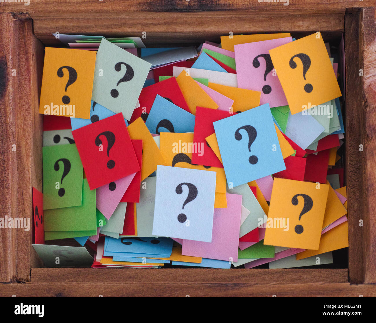 Question marks in a wooden box. Close up. Stock Photo