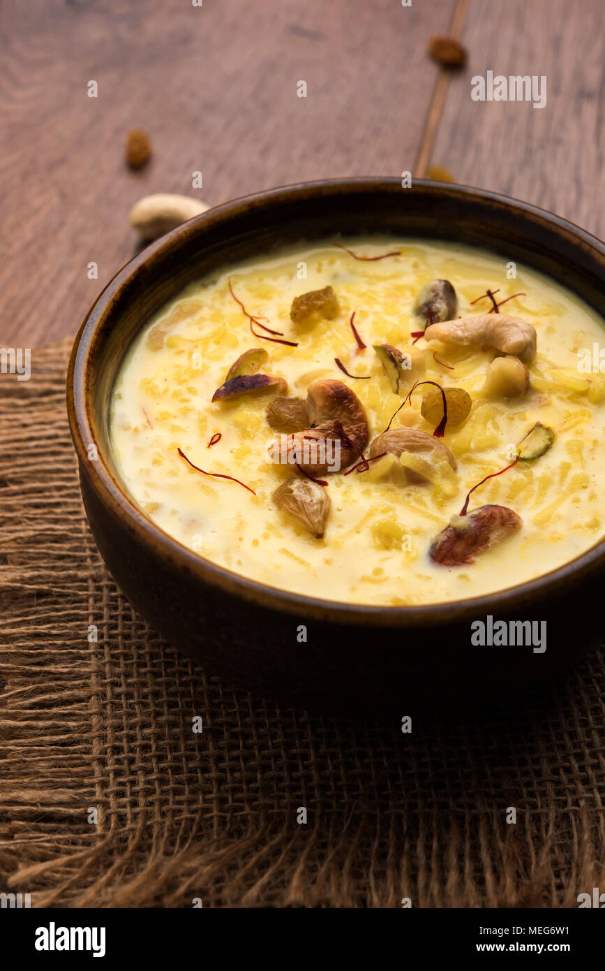 kheer or rice pudding is an Indian dessert in a brown terracotta bowl