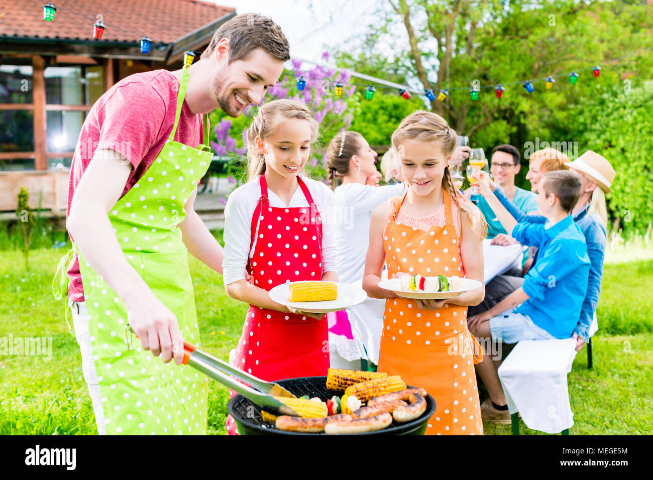 Family having barbeque at garden party Stock Photo Alamy