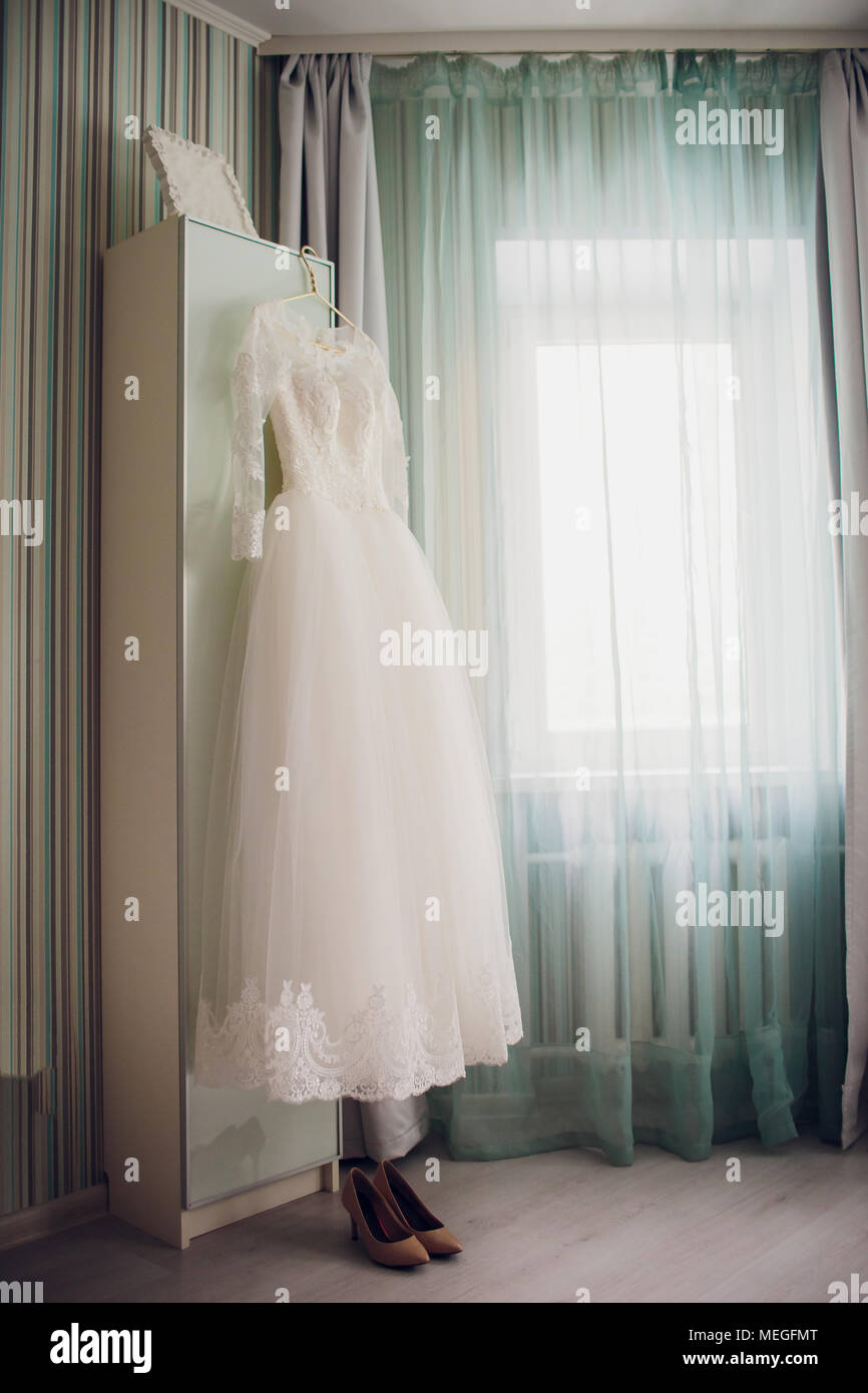 Wedding Dress Hanging On The Closet Door Green Curtains Stock