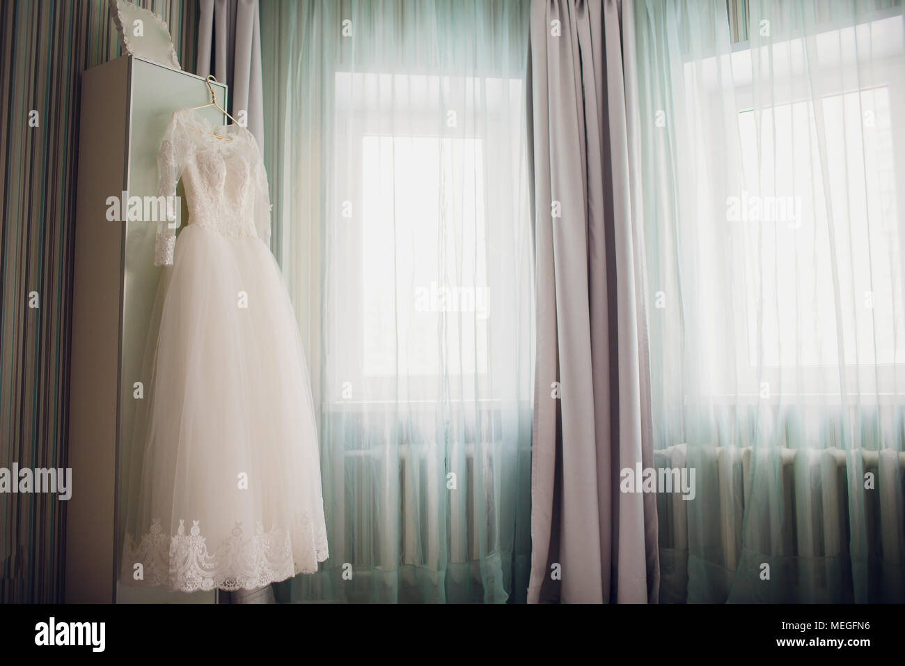 Wedding Dress Hanging On The Closet Door Green Curtains Stock