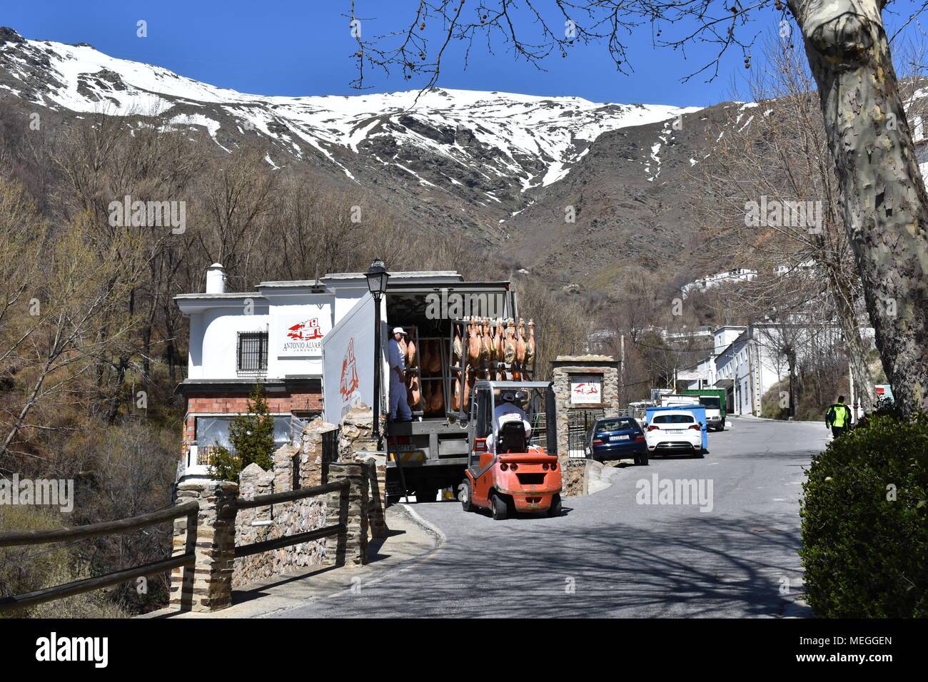 Fork lift truck loading hams into a lorry in Trevelez, a village in Las Alpujarras famous for producing ham, province of Granada, Spain Stock Photo