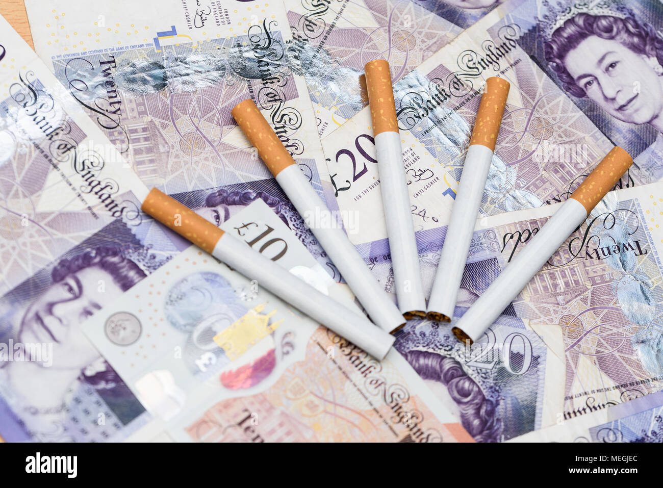 Concept of smoking cost. Cigarettes on a british pound banknote