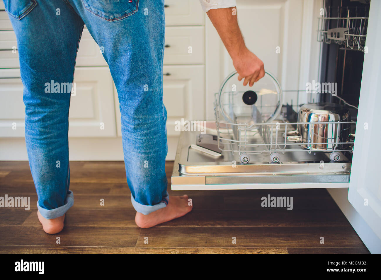 man takes dishes from the dishwasher close up Stock Photo Alamy