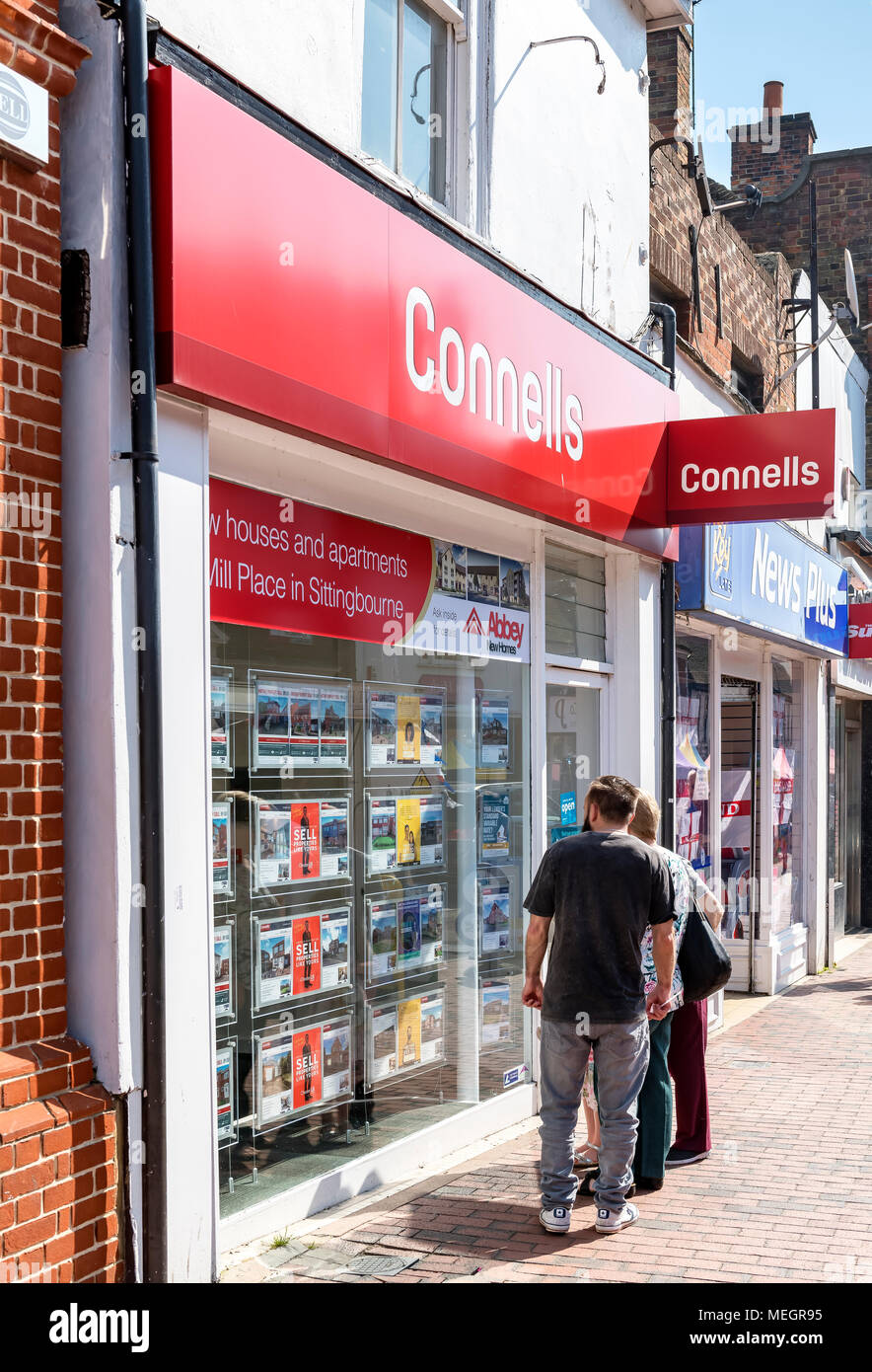 Couple looking at an estate agents listings Stock Photo