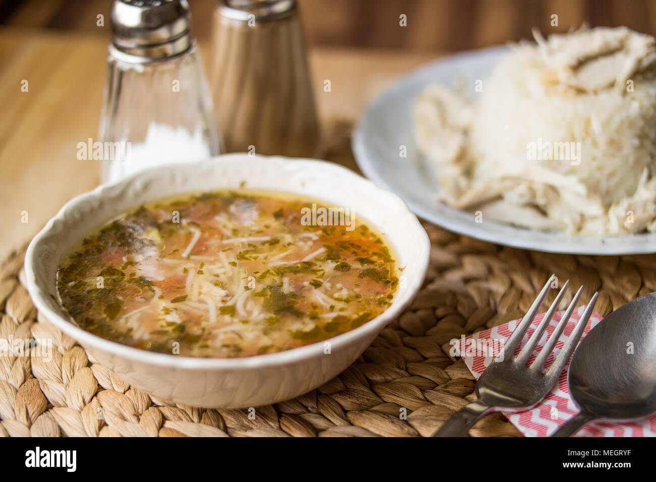 Traditional Turkish chicken broth soup with chicken on a rice pilaf (tavuklu pilav) Stock Photo