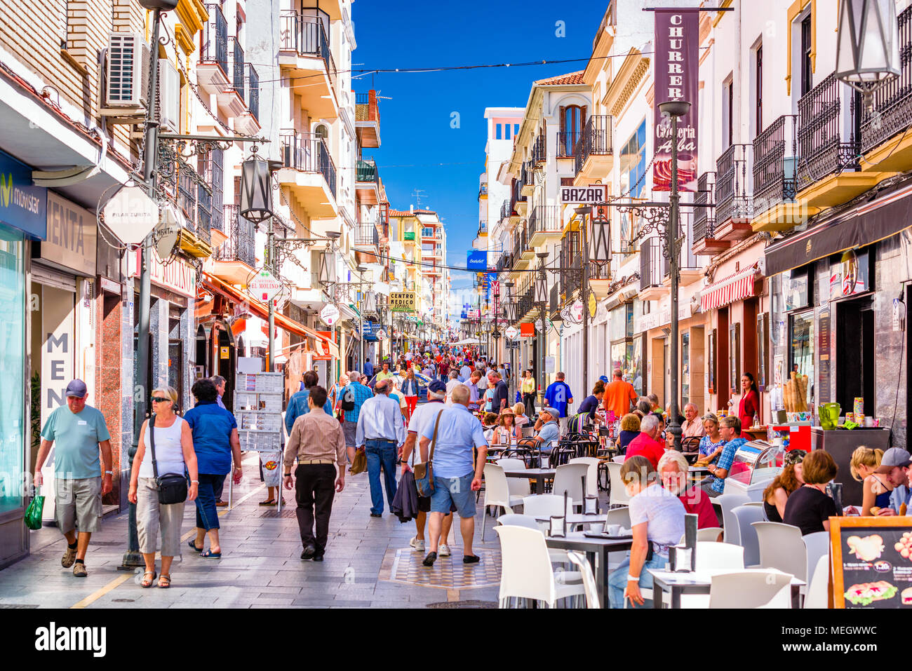 RONDA, SPAIN - OCTOBER 5, 2014: Crowds walk on Calle La Bola pedestrian shopping street in Ronda. Stock Photo