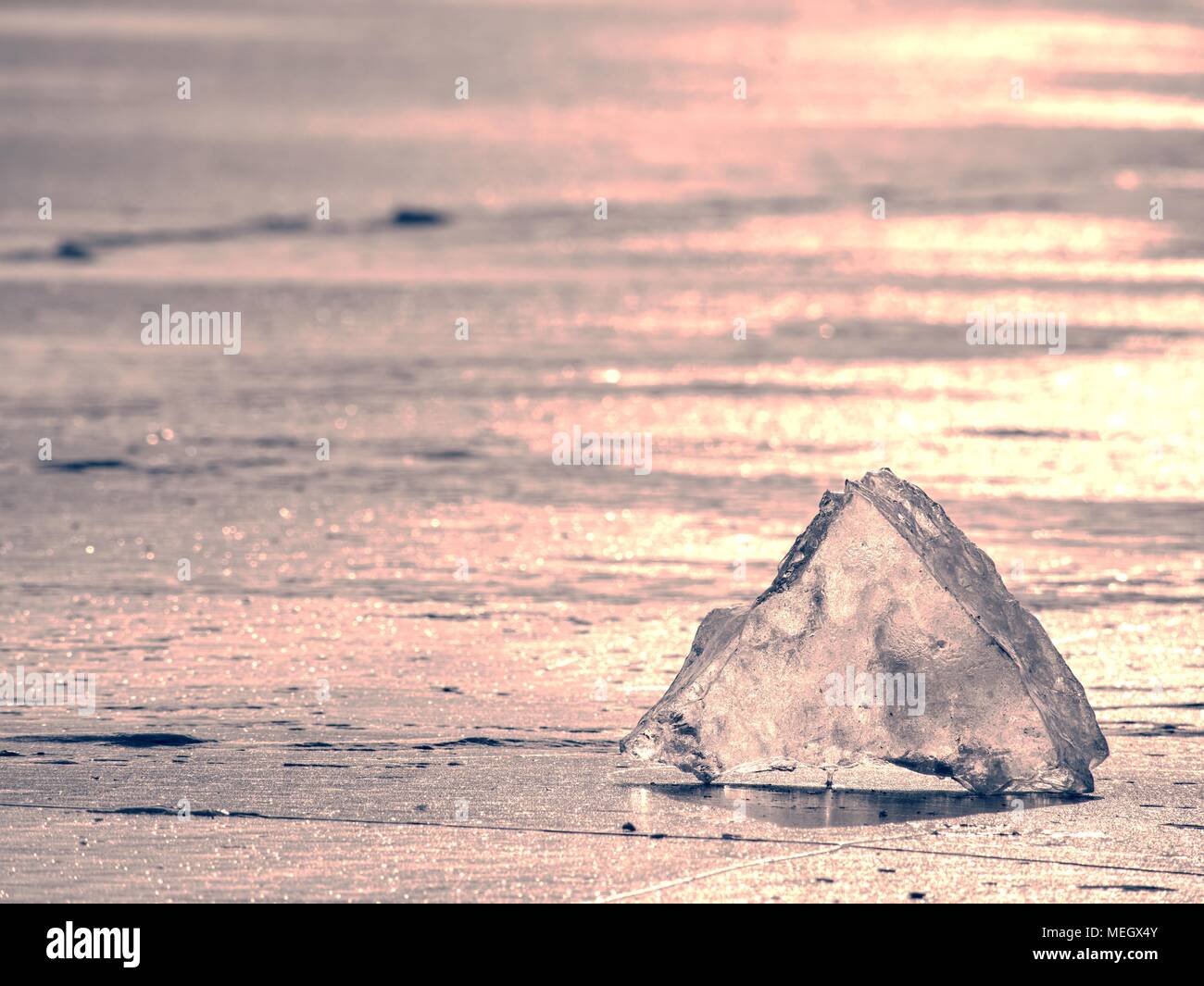 Abstract ice floe on frozen lake. Weathered ice and sparkling of ...