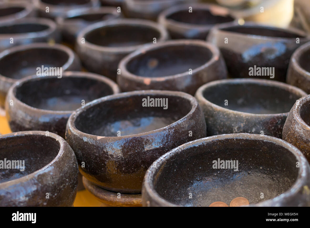 Black monk bowl with coins alms Stock Photo